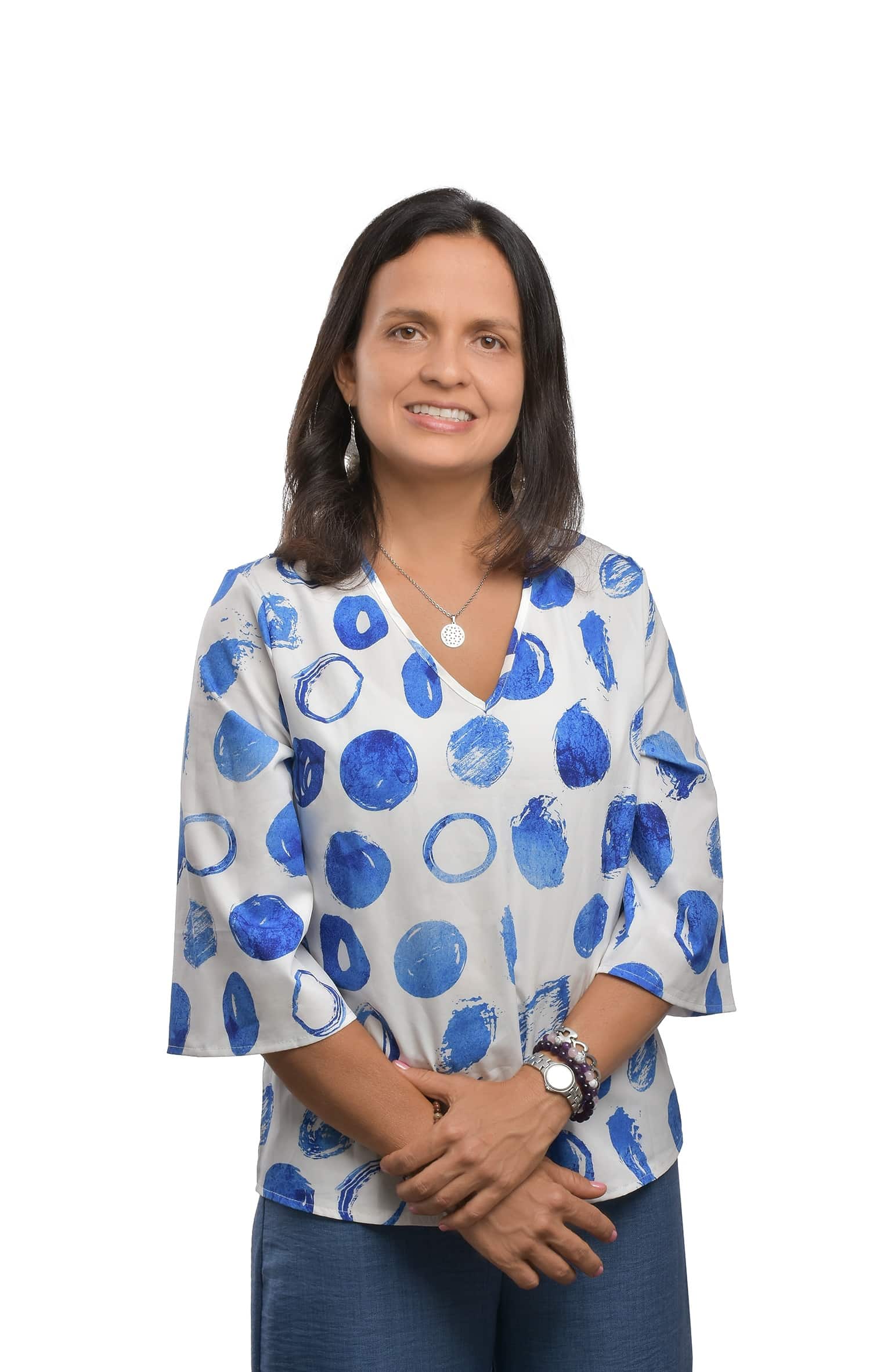 Persona sosteniendo una pequeña flor morada entre las manos, con un anillo en uno de los dedos y vestida con ropa blanca. Logotipo morado de 'Red Espiritual' en la esquina inferior derecha.